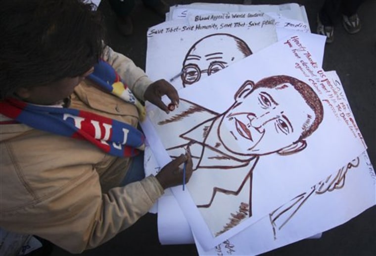 A Tibet Freedom Movement activist makes a portrait of Barack Obama with his blood in Shimla, India, on Thursday.